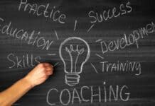 Leading Coaching Models: GROW, FUEL, and STEPPA – When to Use Each One? A hand draws a lightbulb on a chalkboard surrounded by words: Practice, Success, Development, Training, Skills, Education, and Coaching
