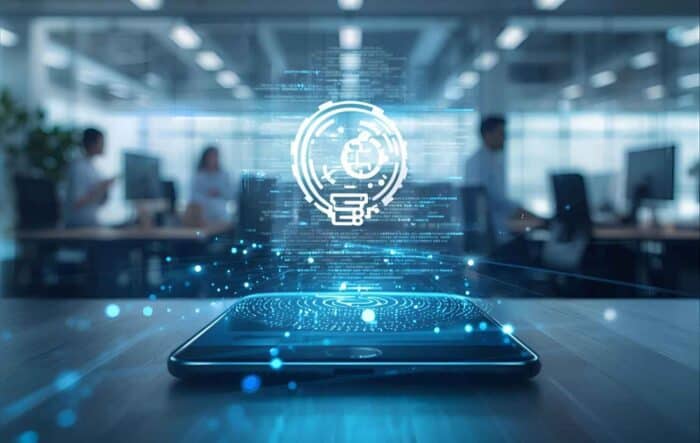 a digital hologram of a lightbulb and data icons emerges from a smartphone on a desk, representing innovation and hybrid cloud technologies in a modern workplace setting