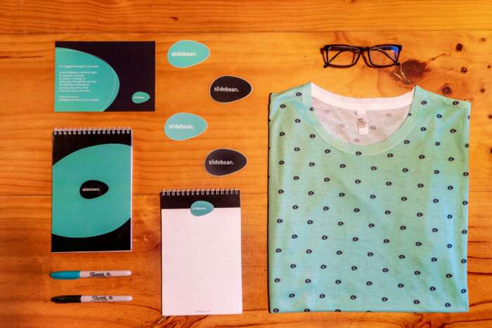 A flatlay of a collection of branded apparel on a wooden table.