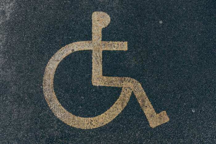 Photo by Jakub Pabis: https://www.pexels.com/photo/painted-disability-icon-on-asphalt-pavement-11074333/